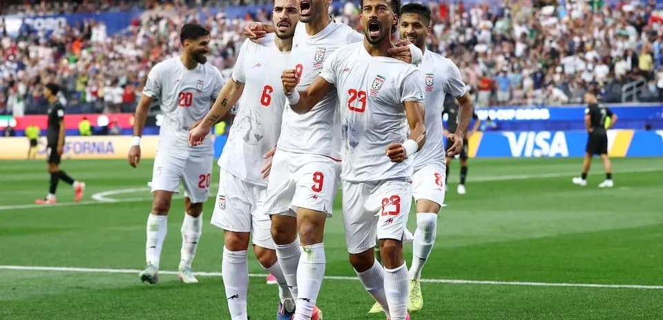 Iran players celebrating during a football match