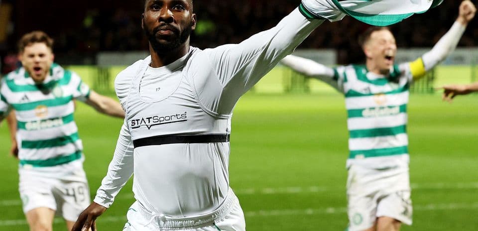 Player celebrating with teammates after scoring goal