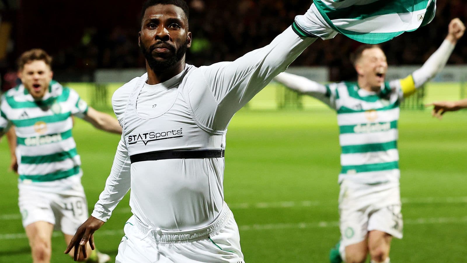 Player celebrating with teammates after scoring goal