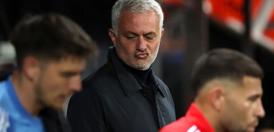 Coach observing players on the sidelines during match