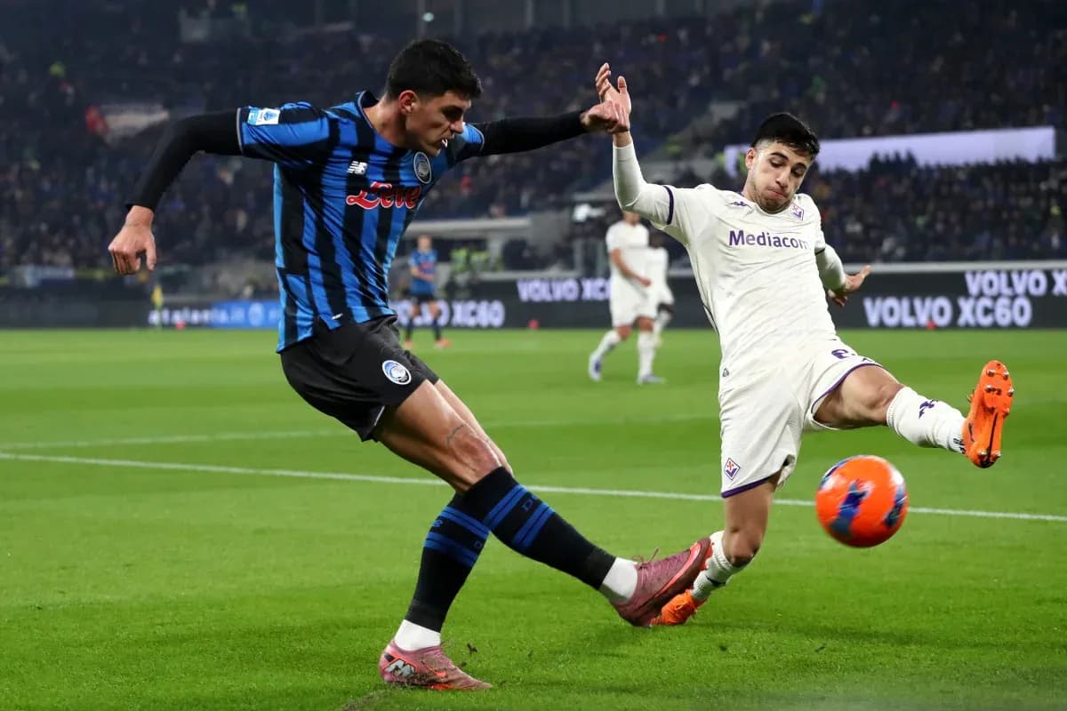 Fiorentina player challenging Atalanta opponent for ball