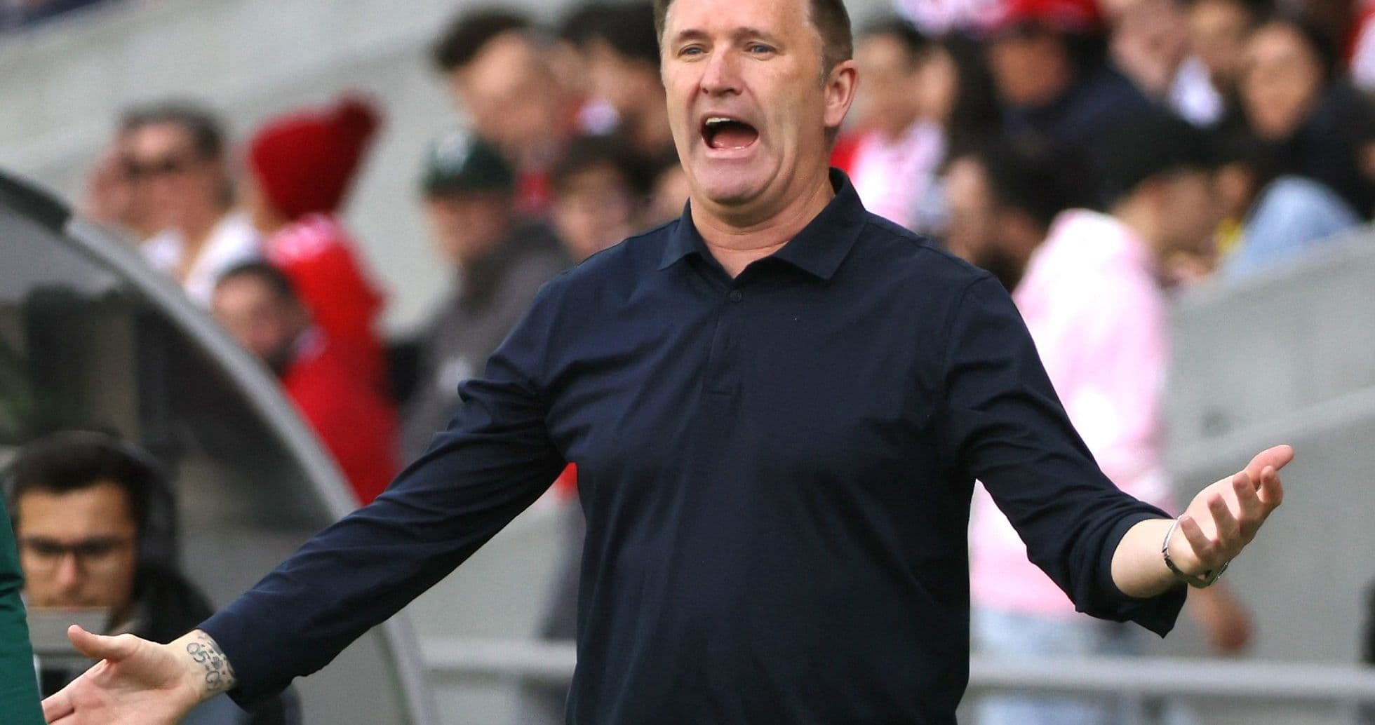 Coach gesturing and speaking during a match