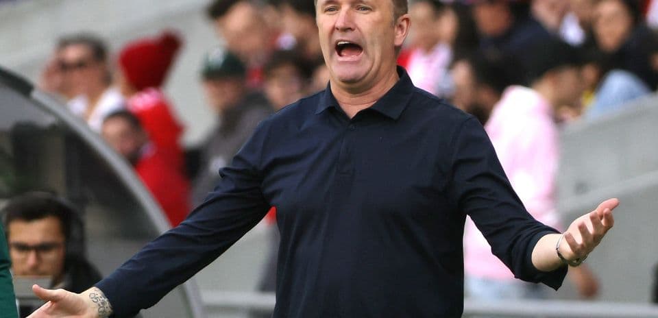 Coach gesturing and speaking during a match