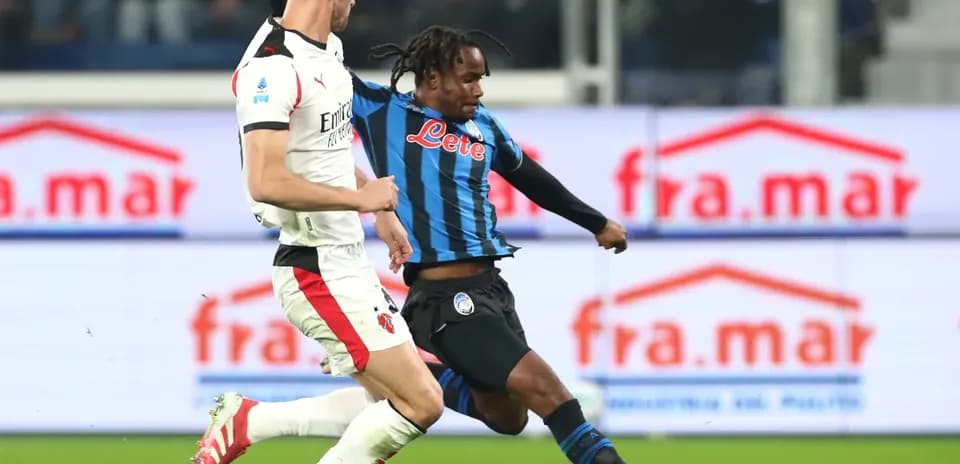 Player tackling opponent during AC Milan vs Atalanta