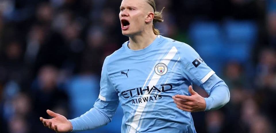 Player in Manchester City kit gesturing during match