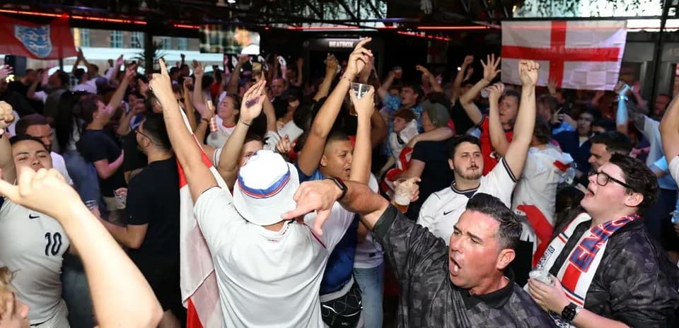 Crowd of fans celebrating in sports bar