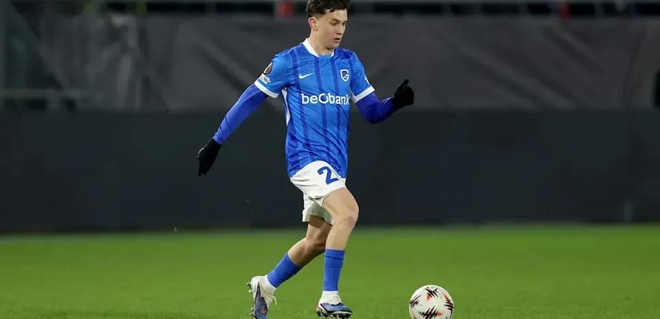 Player in blue jersey dribbling a soccer ball