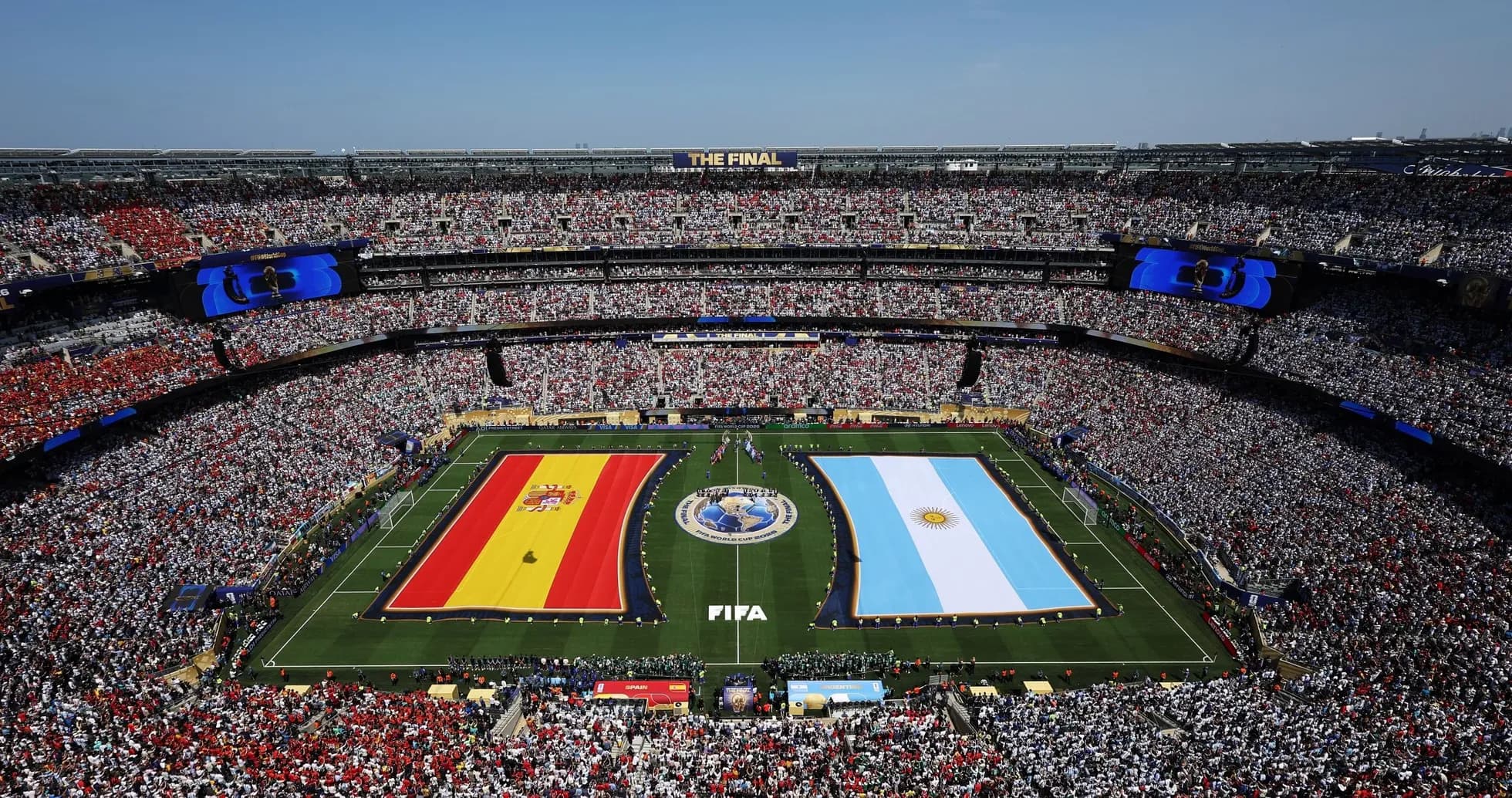 Spain and Argentina flags displayed on field