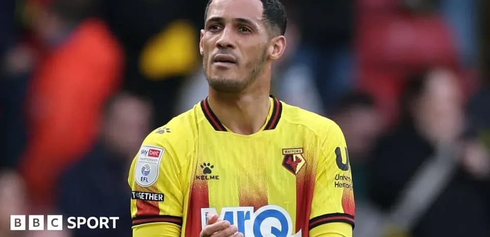 Watford player applauding fans after a match