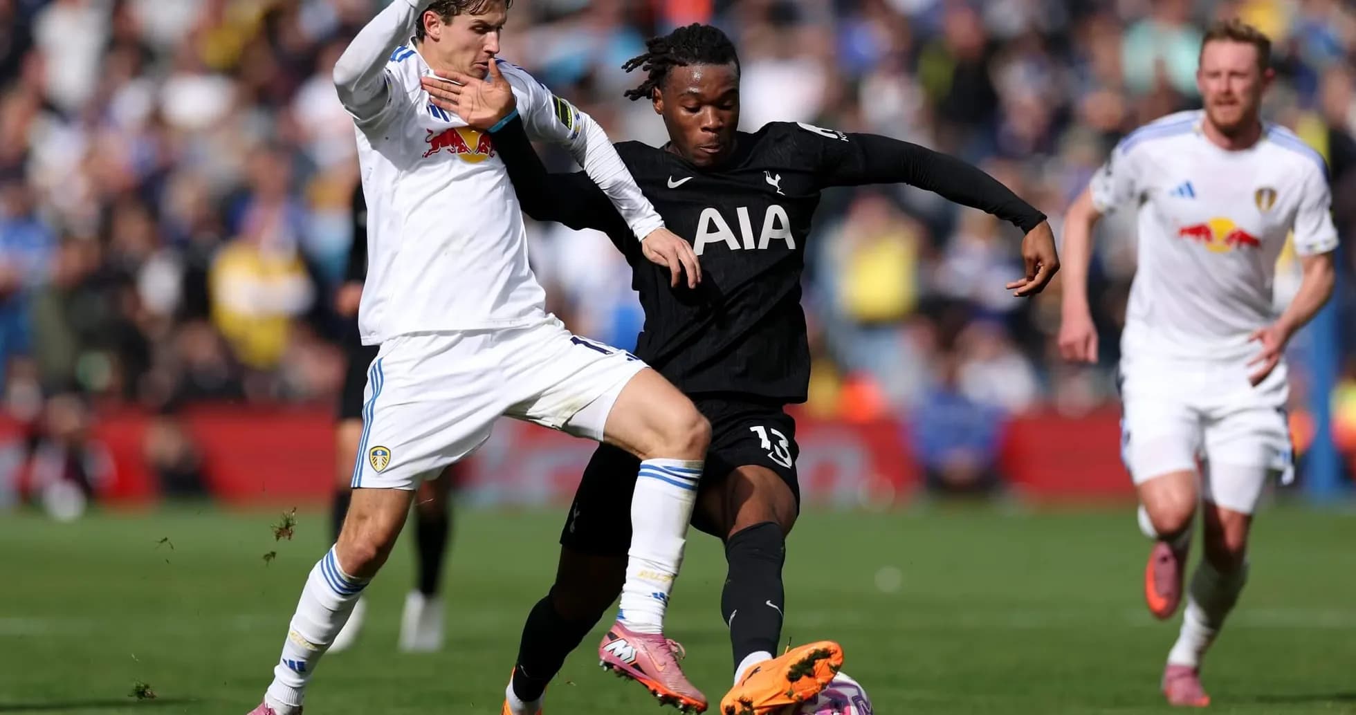 Tottenham player tackling Leeds opponent during match