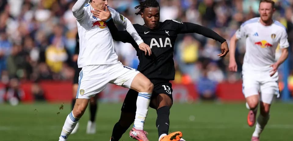 Tottenham player tackling Leeds opponent during match
