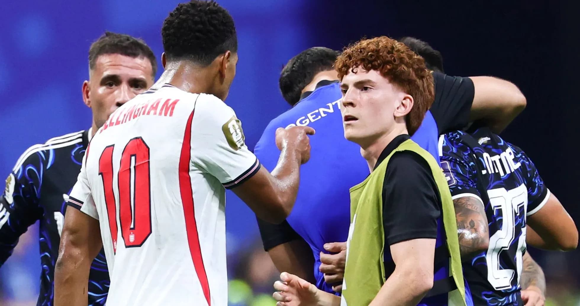 Players interacting on the pitch after a match