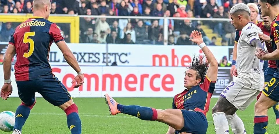 Genoa player tackling Fiorentina opponent during match