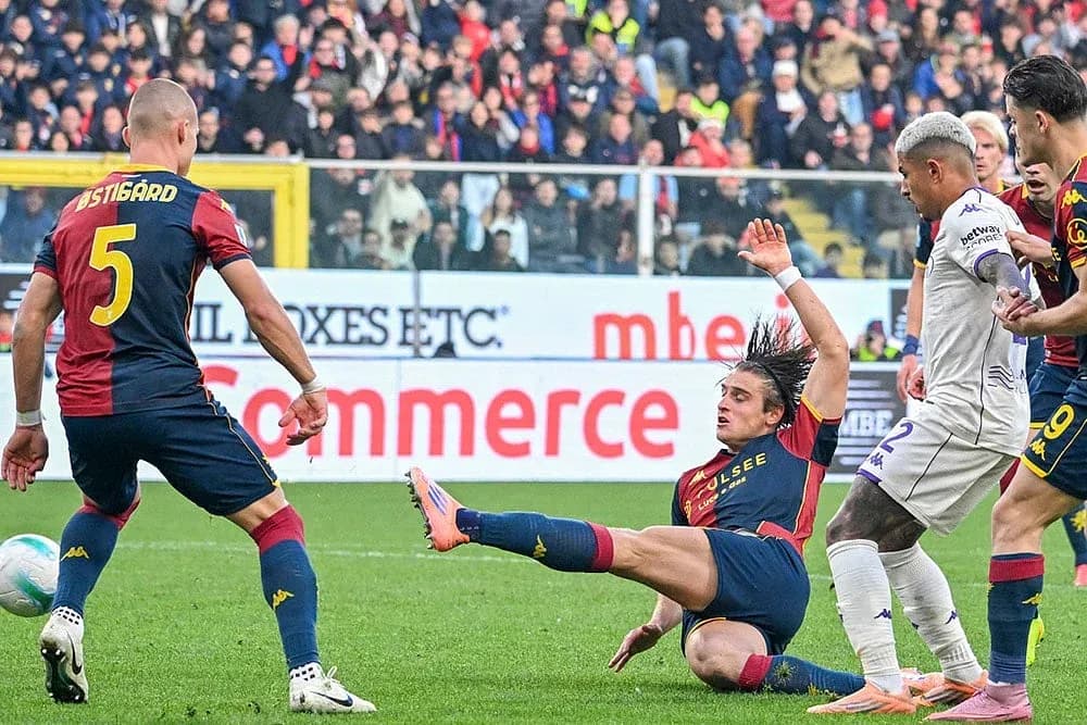 Genoa player tackling Fiorentina opponent during match