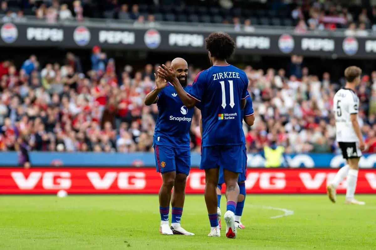 Two players celebrating on the field during match