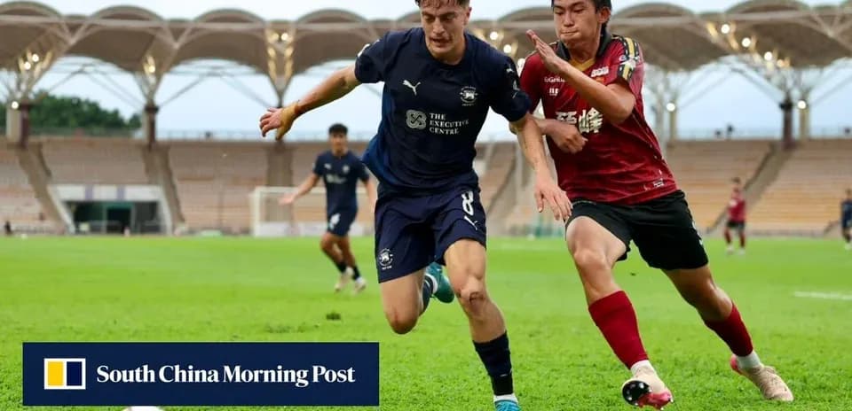 Player in blue jersey running with ball, red opponent chasing