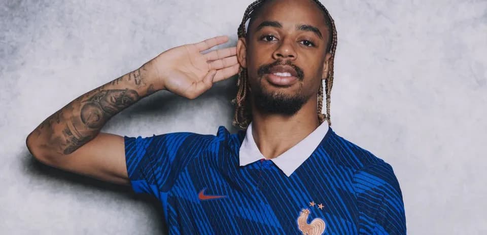 Player in blue France national team jersey posing