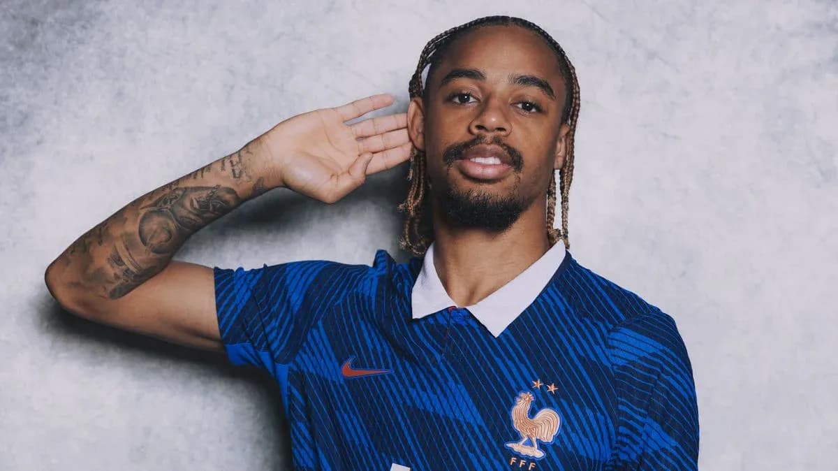 Player in blue France national team jersey posing