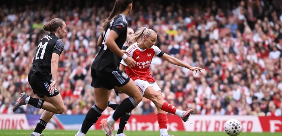Arsenal player striking the ball during match