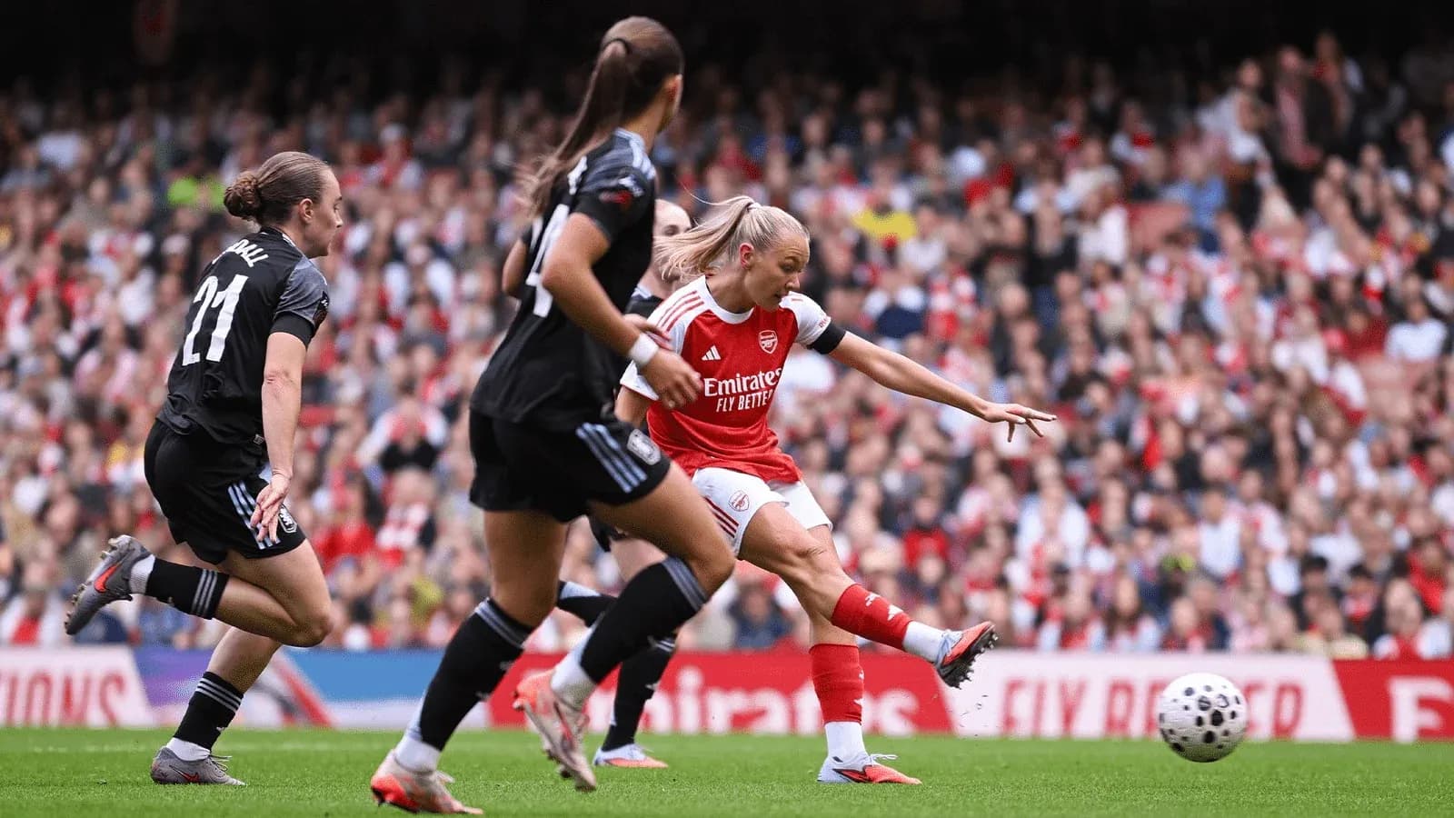 Arsenal player striking the ball during match
