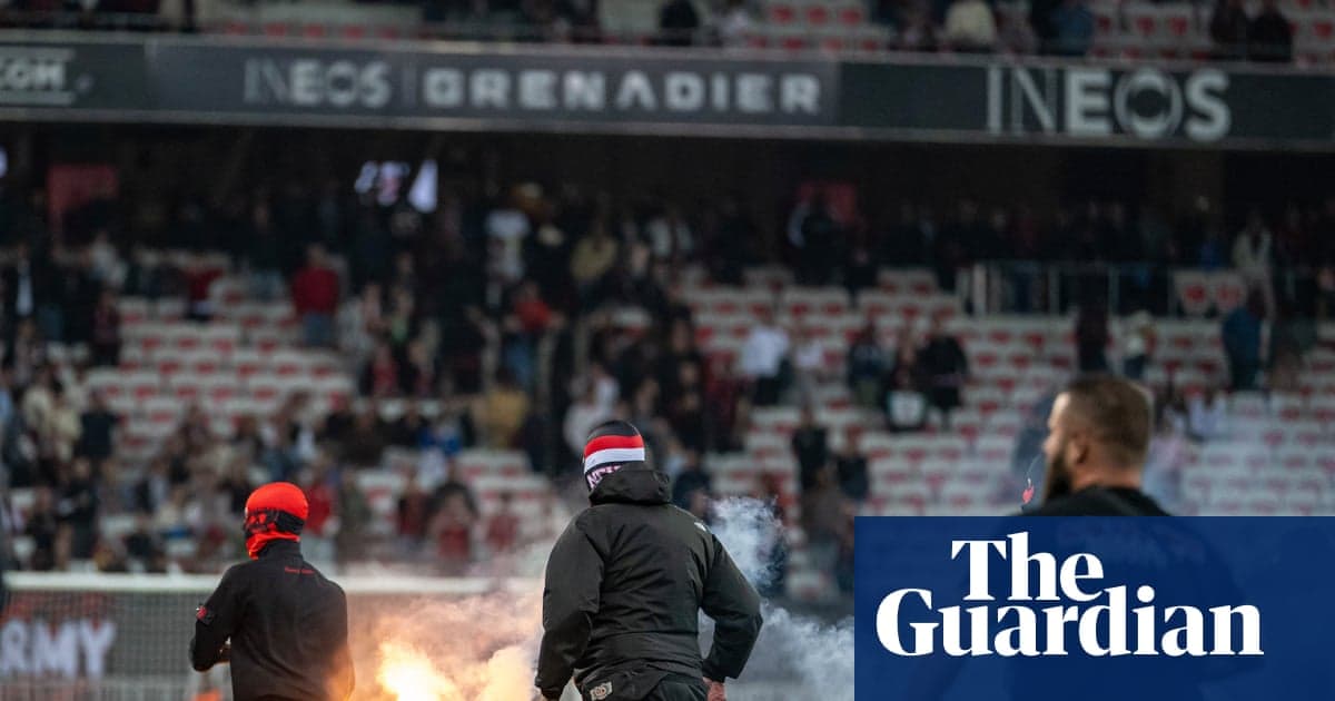 Fans igniting flares in stadium during match