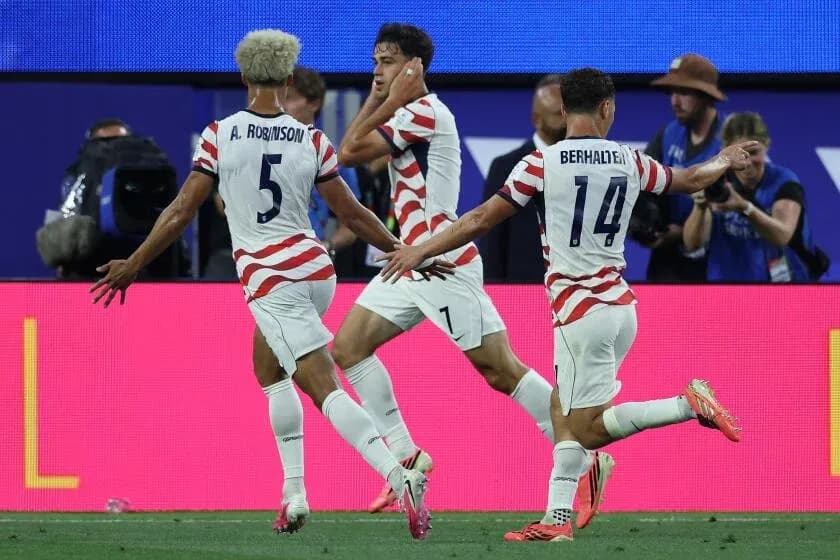 US players celebrating a goal during the match