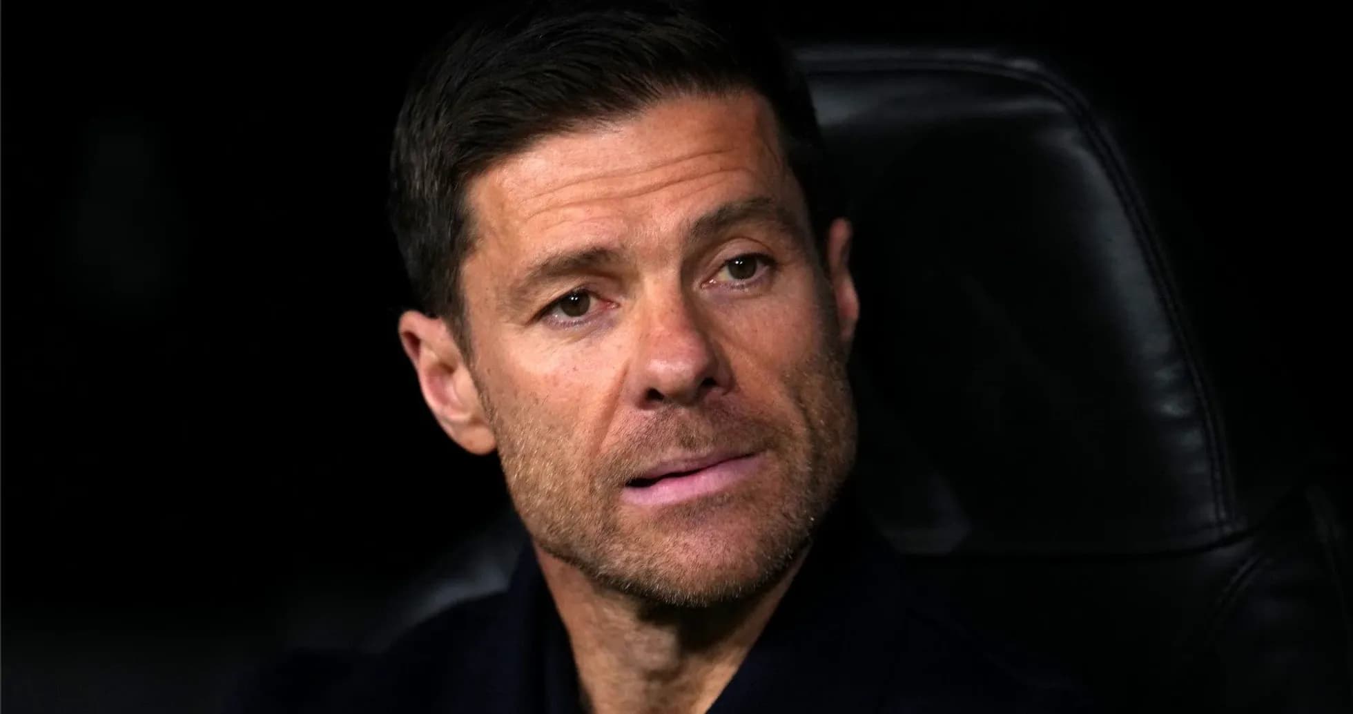 Coach seated on the bench during a match