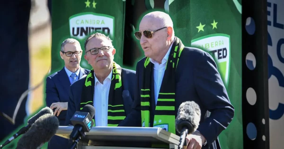 Officials at Canberra United press conference with scarves
