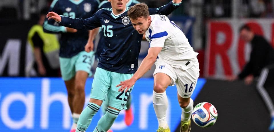 Finland player challenged by Germany player during match