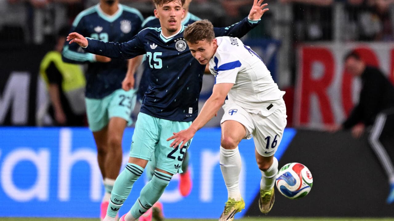 Finland player challenged by Germany player during match