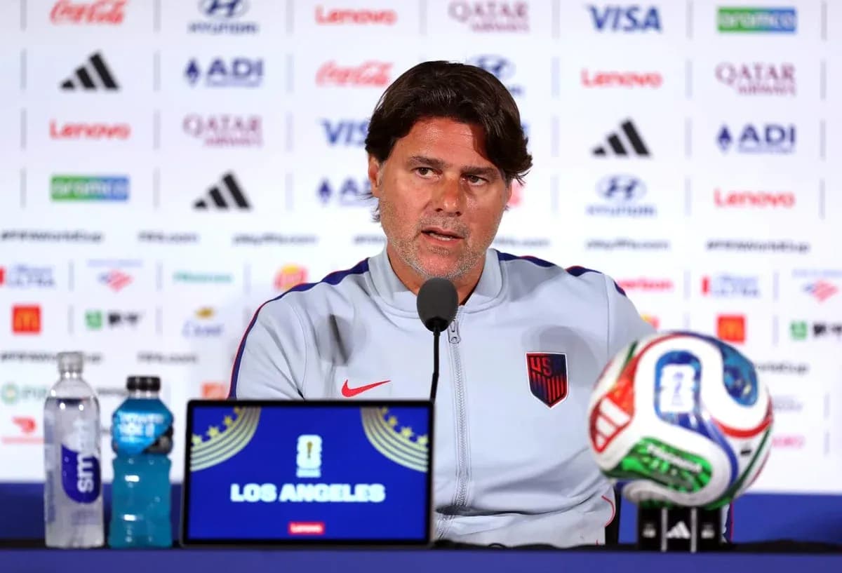 Manager speaking at press conference with soccer ball