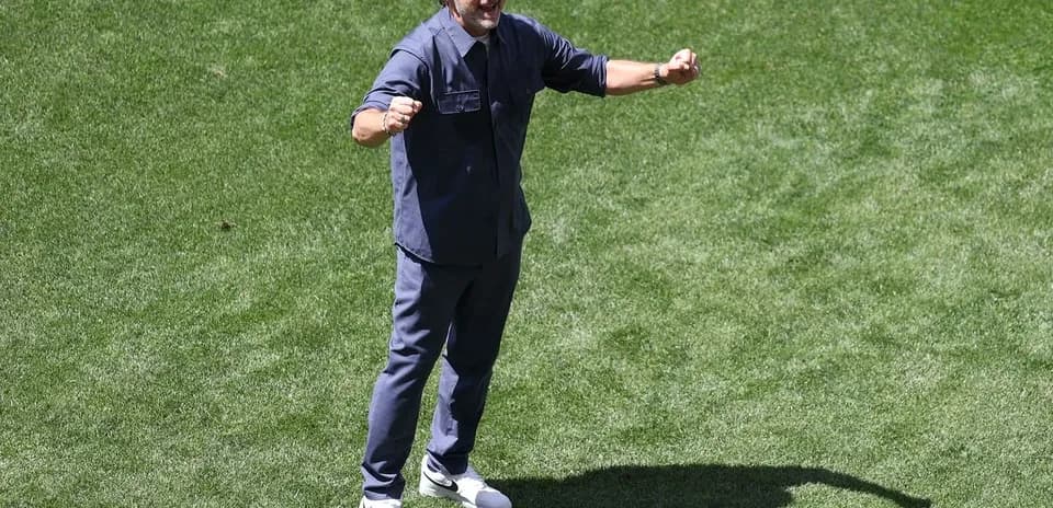 Coach celebrating on the field during training