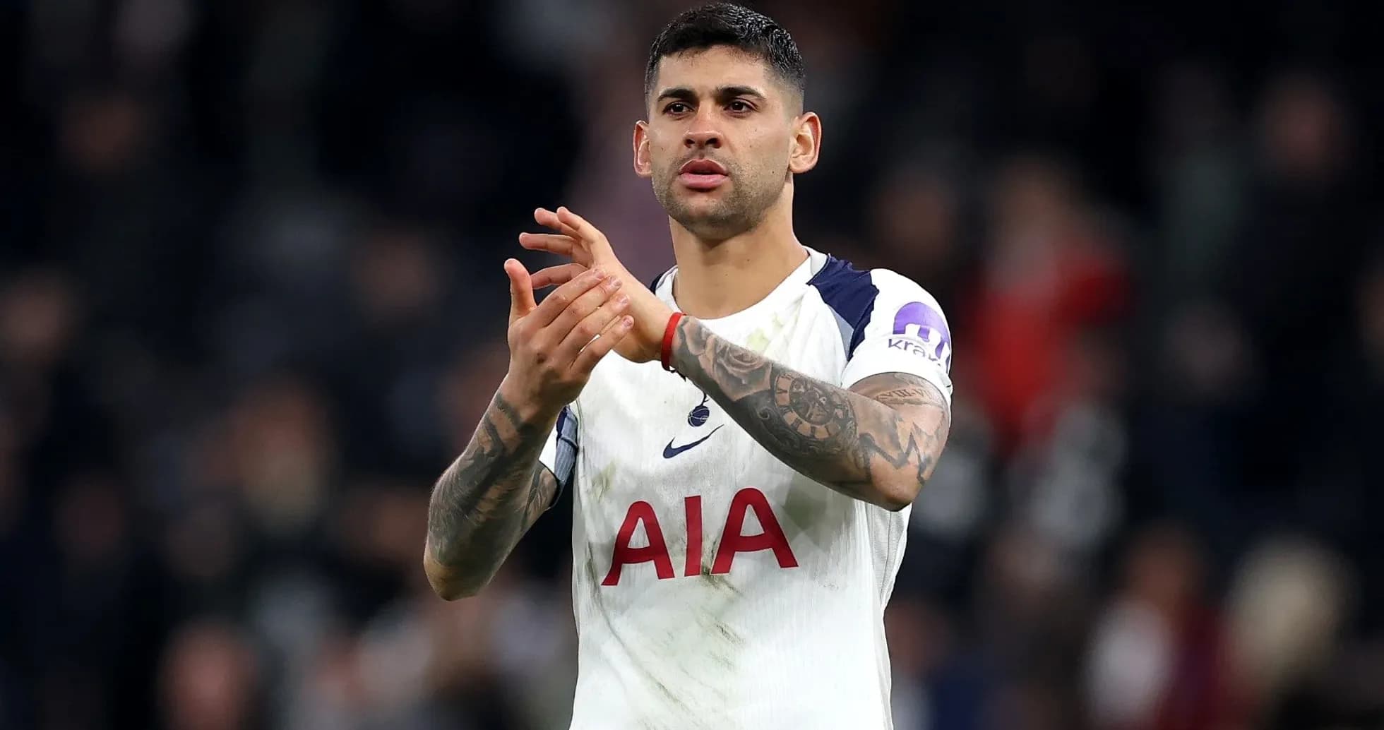Player applauding fans after match in stadium