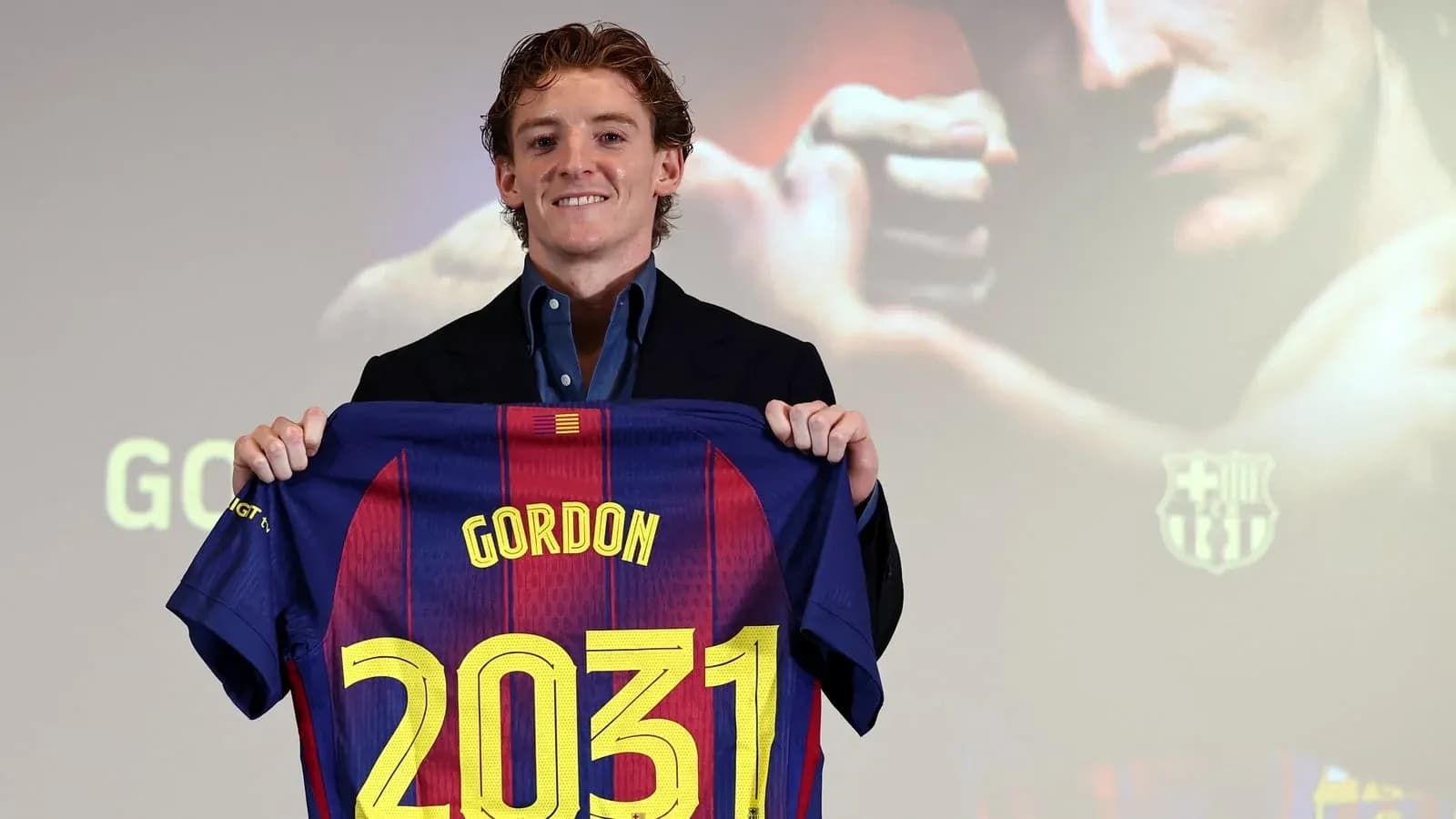Player holding FC Barcelona jersey with name and number