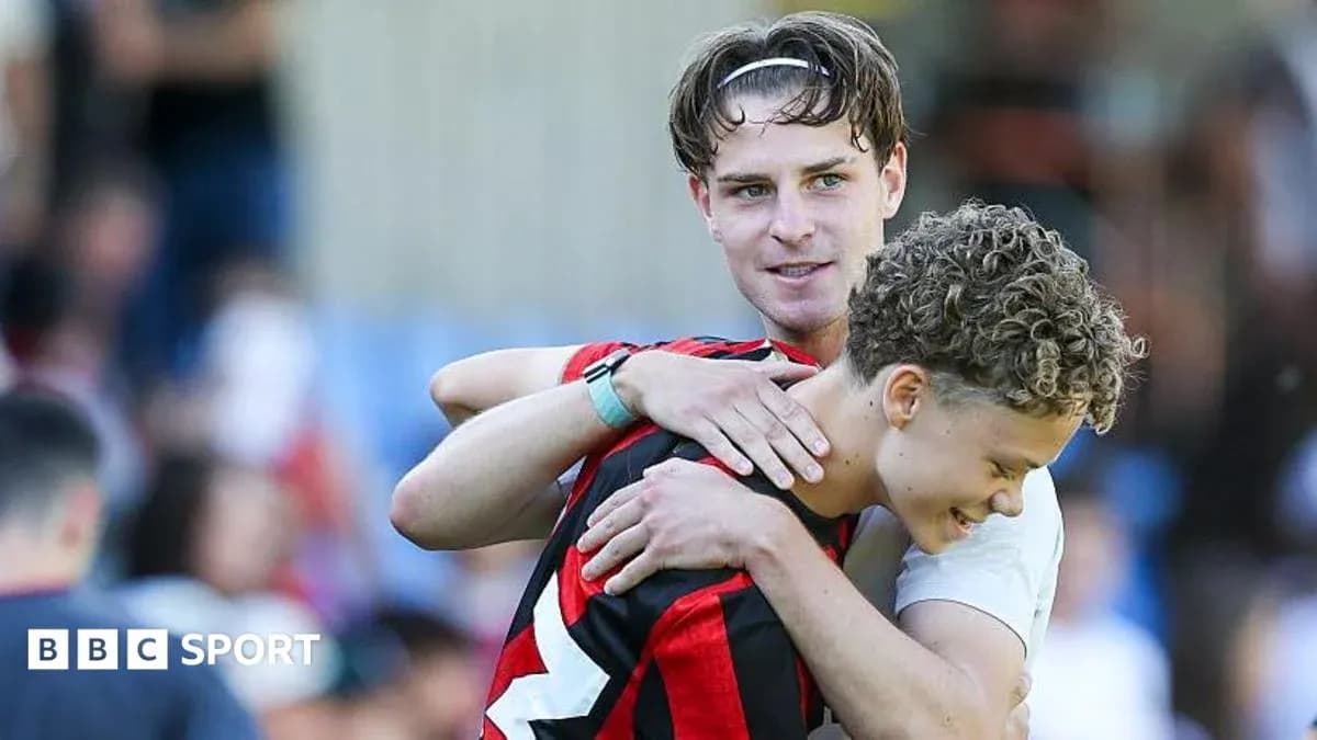 Two football players embracing after a match