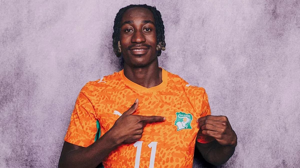 Player pointing to Ivory Coast team logo on jersey