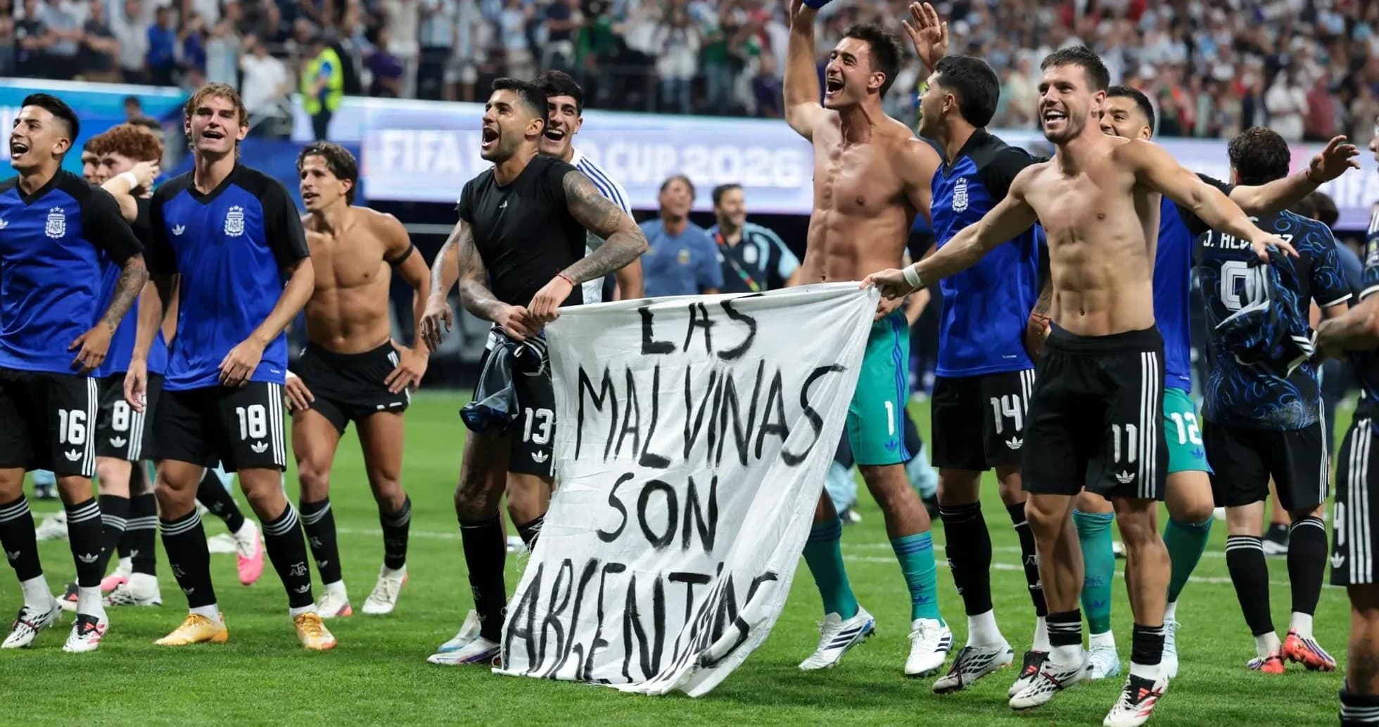 Argentina players celebrating with a banner after match