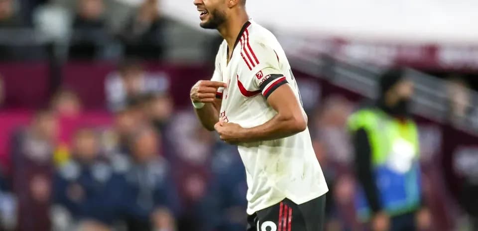 Player reacting during a match with red and white kit