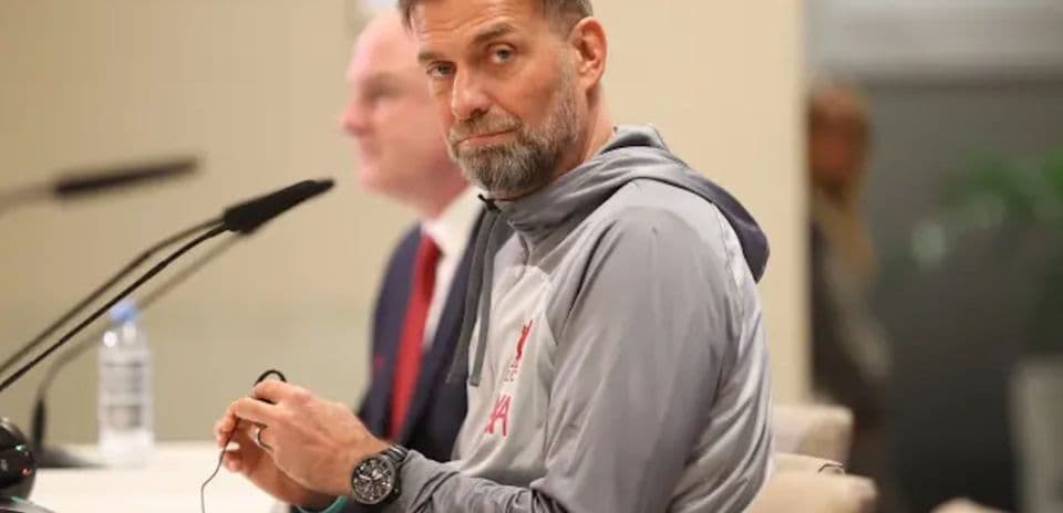 Manager at press conference with microphone and notes