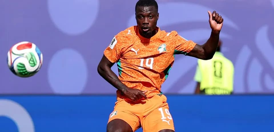 Player in orange jersey controlling the ball during match