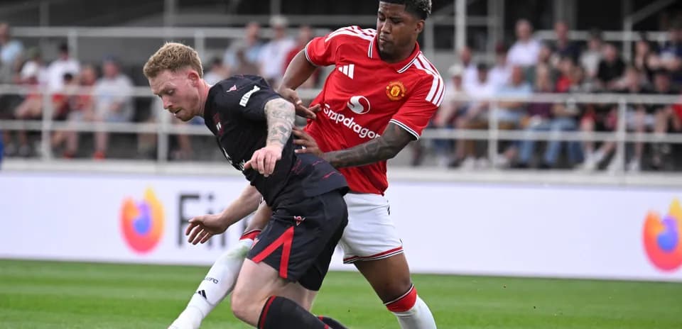 Two players battling for the ball on field