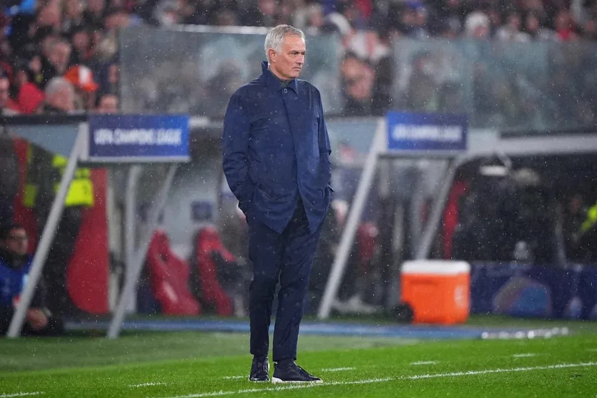 Coach observing match during rainy conditions
