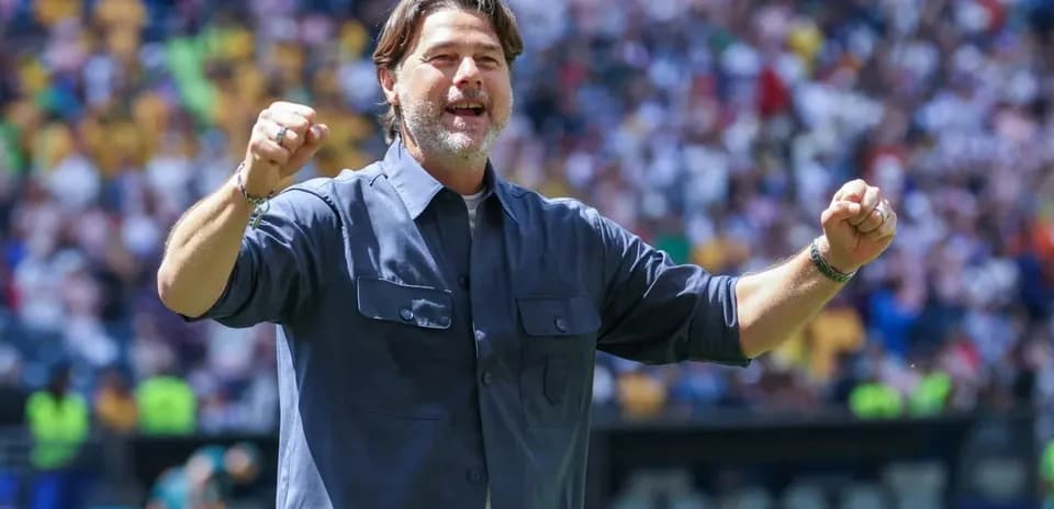Coach celebrating during match at stadium