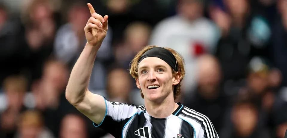 Newcastle player celebrating a goal with raised finger