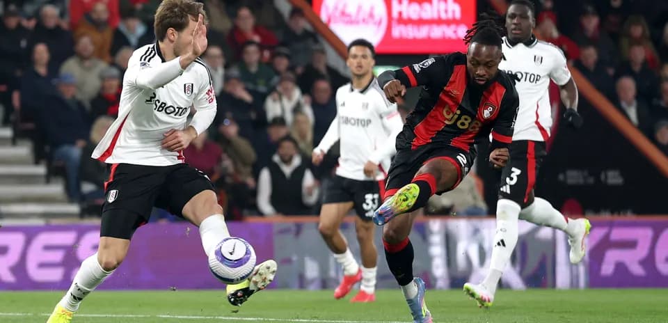 Fulham player challenging Bournemouth attacker