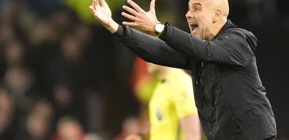 Coach gesturing during a football match on sideline