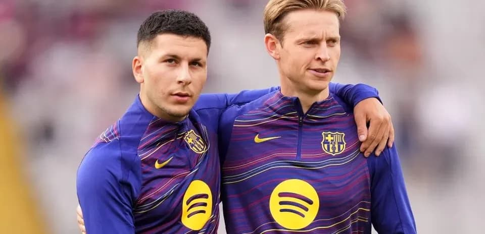 Two players in FC Barcelona training kits posing together