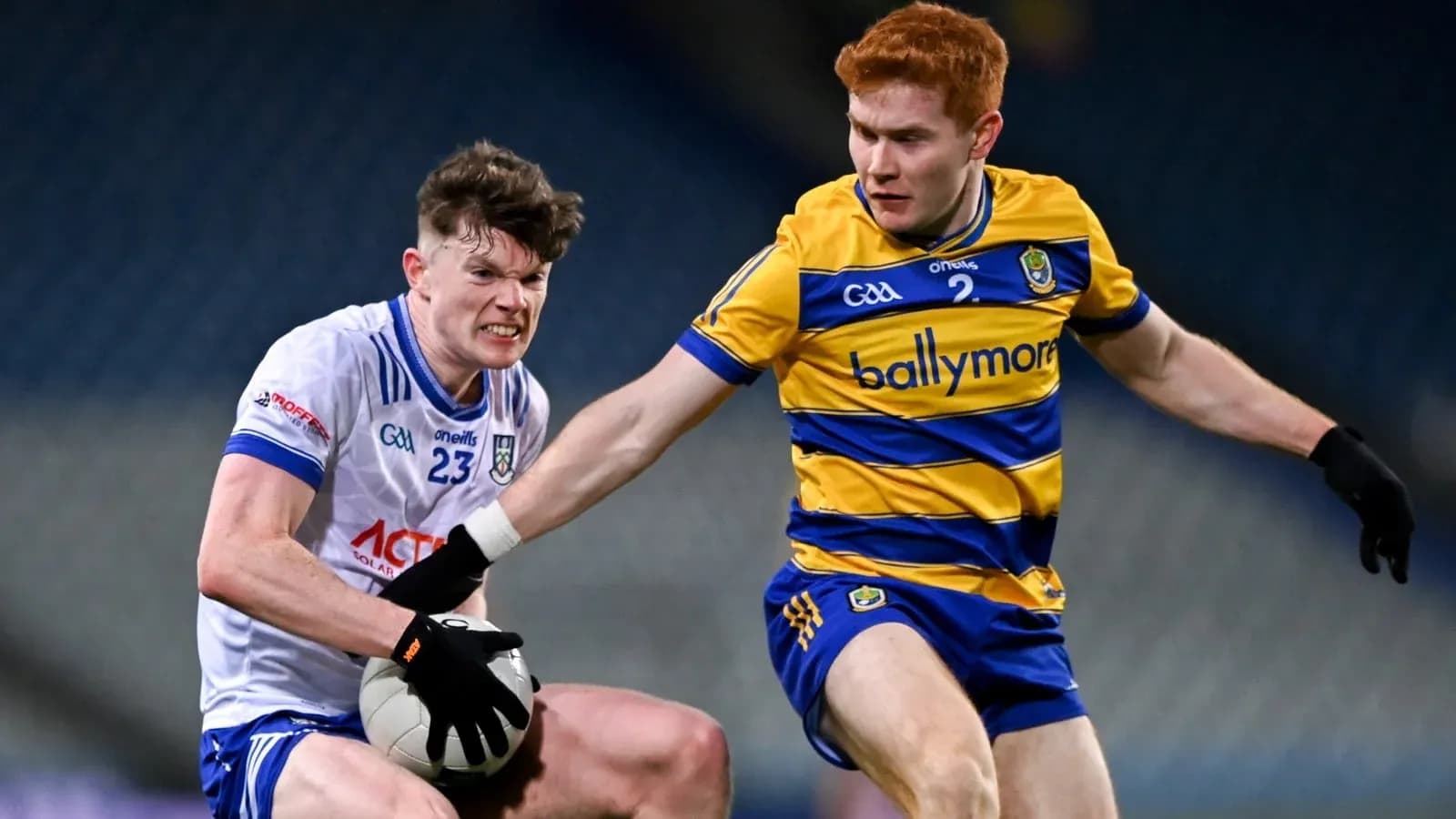 Two players contesting for a Gaelic football Two players contesting for a Gaelic football