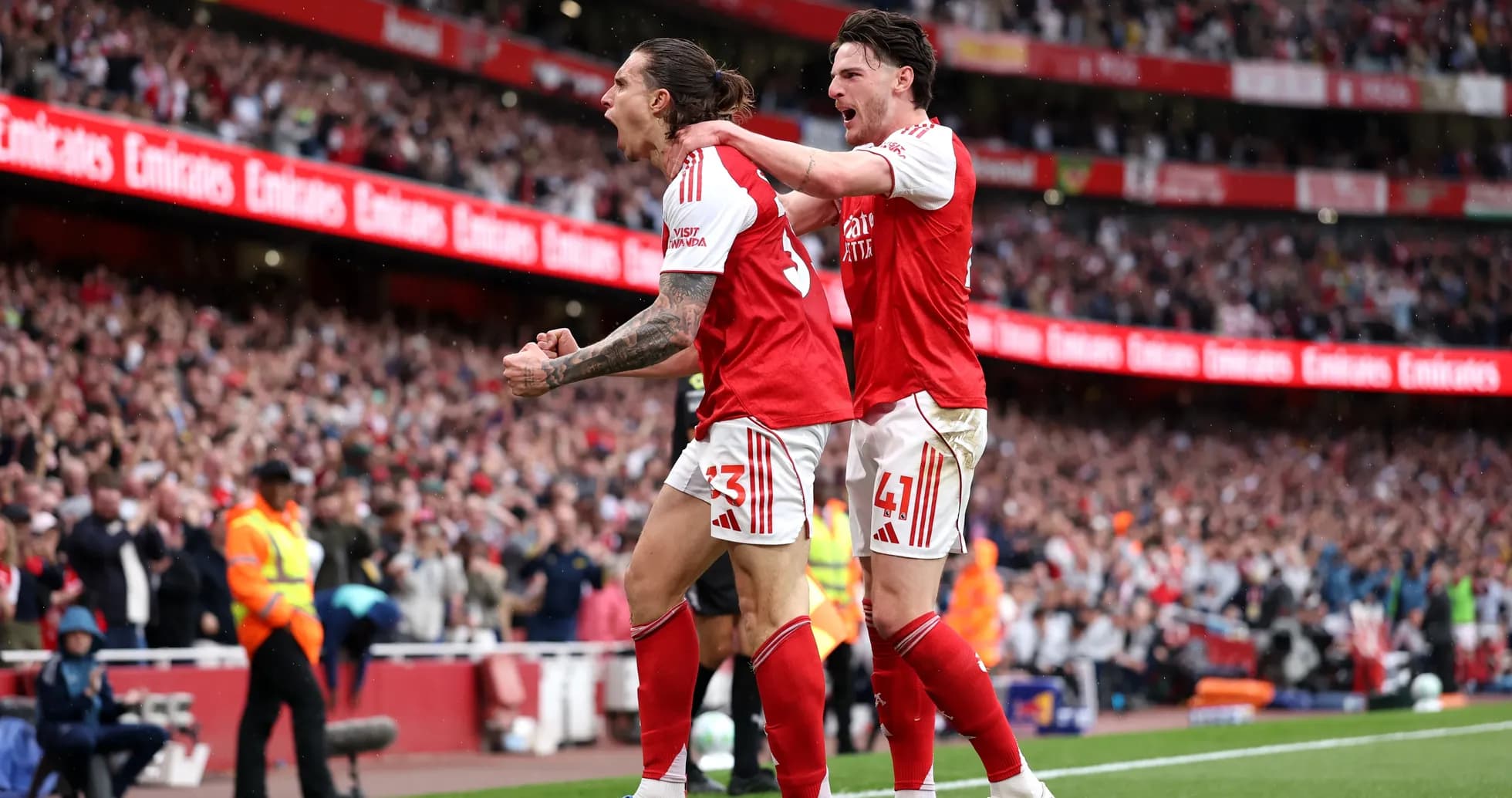 Two Arsenal players celebrating a goal at Emirates Stadium