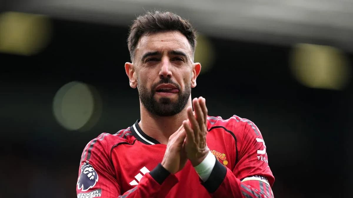 Player applauding fans in Manchester United jersey